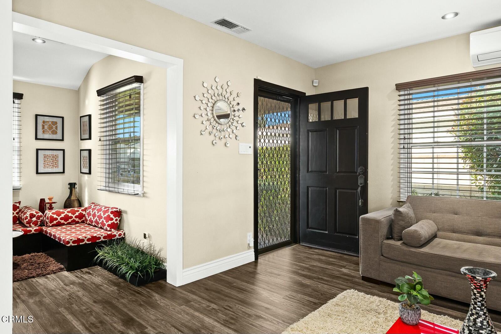 6708 Ranchito Avenue Van Nuys, CA 91405 - Photo 4 of 37 a living room with furniture and wooden floor