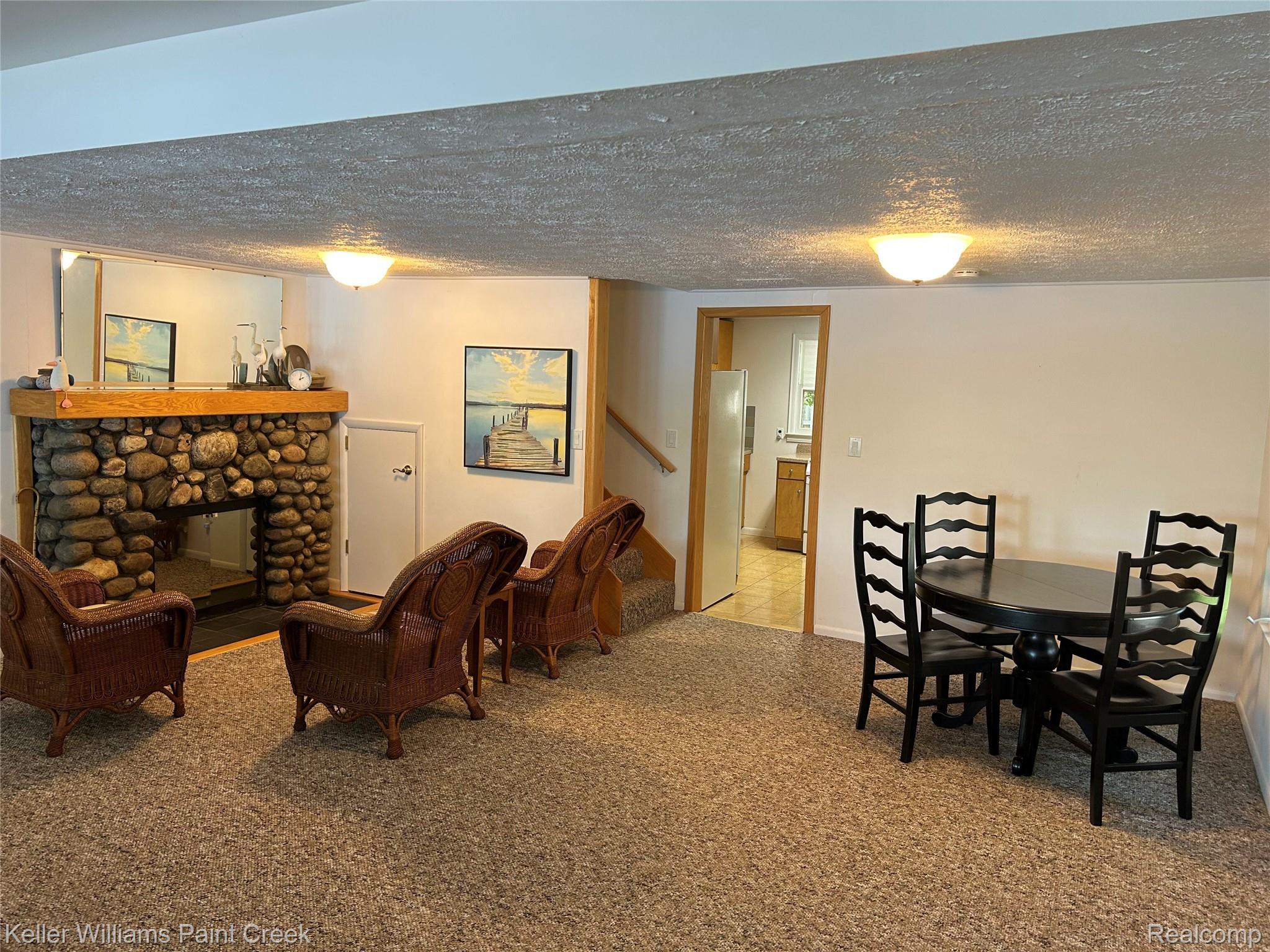 227 Ora Road Oxford, MI 48371 - Photo 15 of 60 Expansive room featuring a stone-faced fireplace with a wood mantel, soft carpet flooring, and recessed lighting