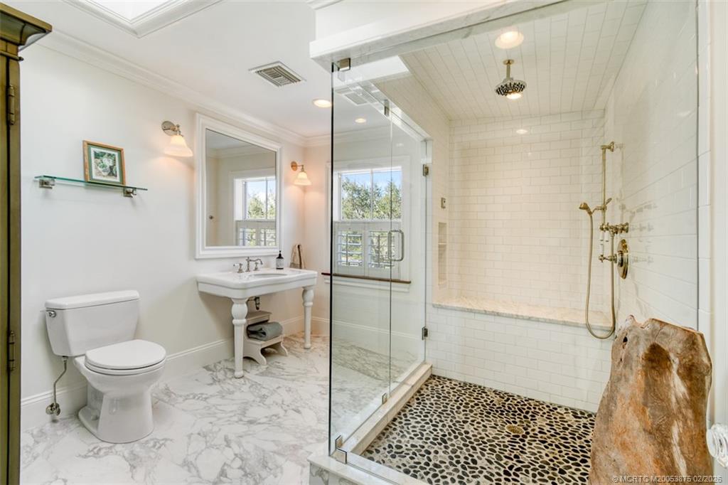 2541 Southwest Trailside Path Stuart, FL 34997 - Photo 70 of 100 a bathroom with a toilet a sink and a shower