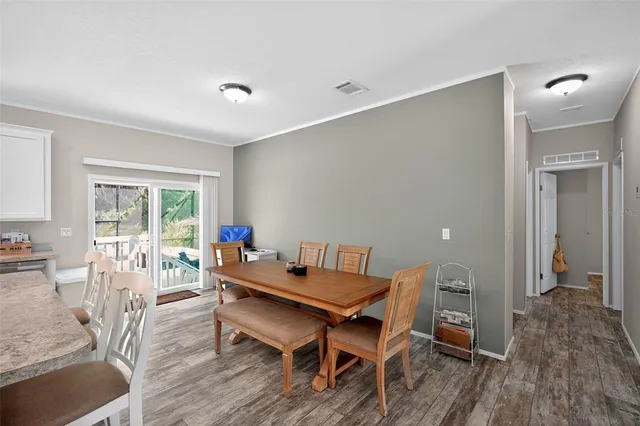 a dining room with furniture and wooden floor
