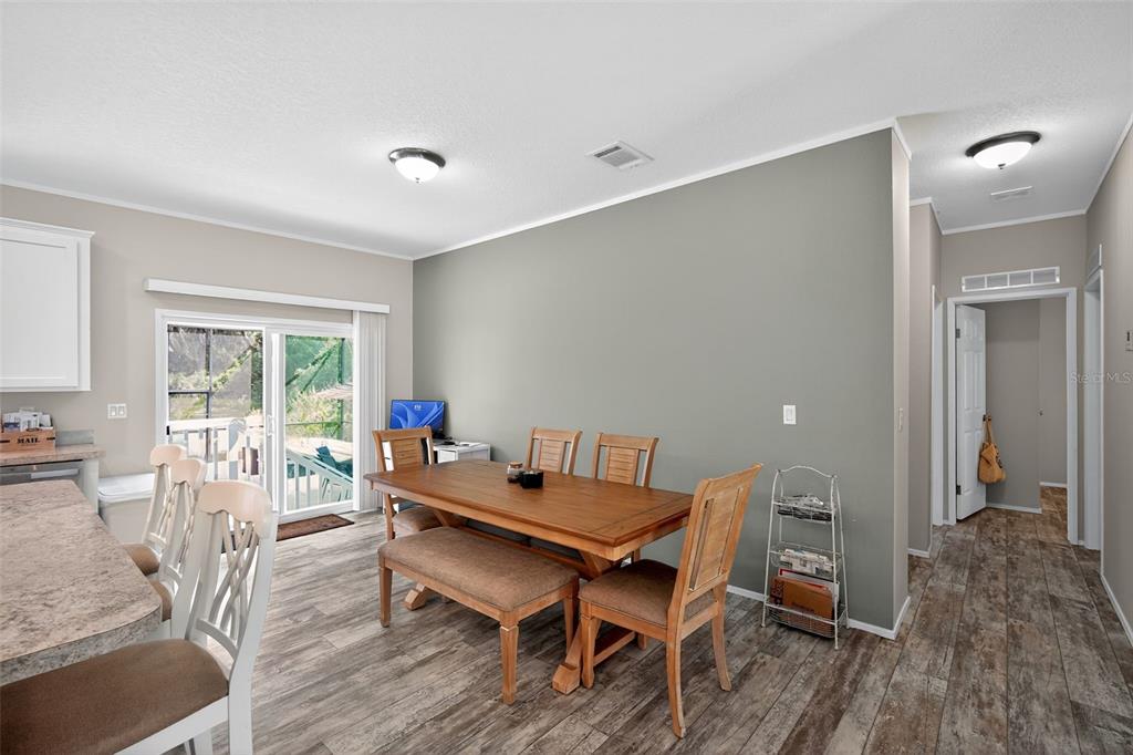 12706 McIntosh Road Plant City, FL 33565 - Photo 12 of 30 a dining room with furniture and wooden floor