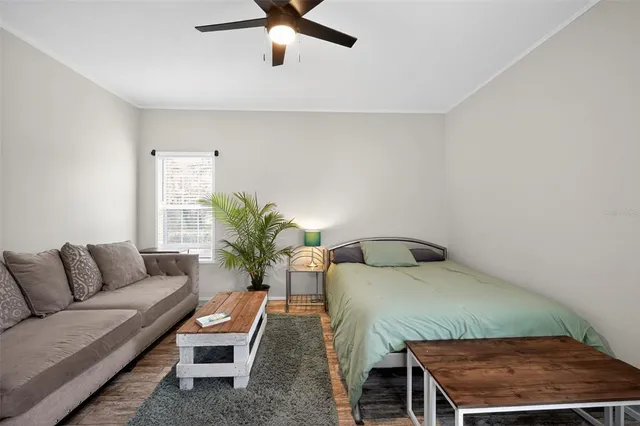 a bedroom with a bed window and couch