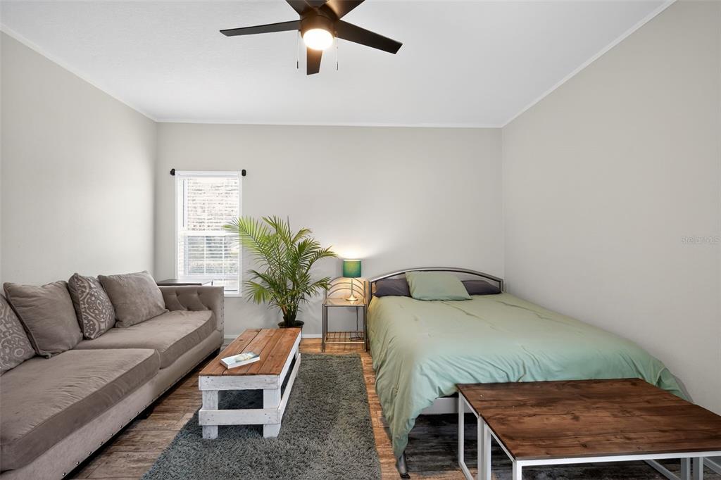 12706 McIntosh Road Plant City, FL 33565 - Photo 13 of 30 a bedroom with a bed window and couch