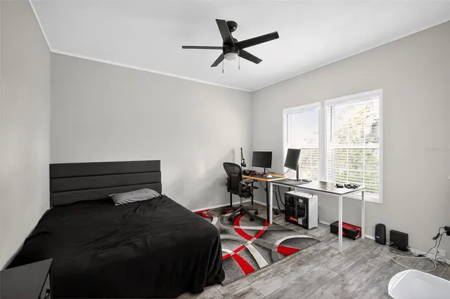 a bedroom with a bed and a desk