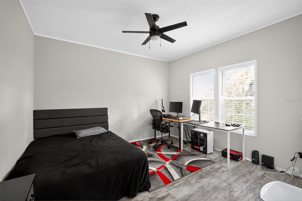 12706 McIntosh Road Plant City, FL 33565 - Photo 22 of 30 a bedroom with a bed and a desk