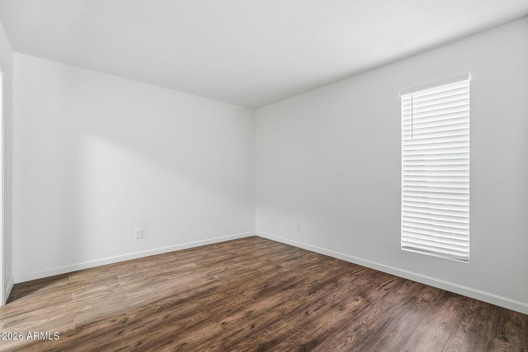 231 North Robson, Unit 7 Mesa, AZ 85201 - Photo 16 of 29 an empty room with wooden floor and windows