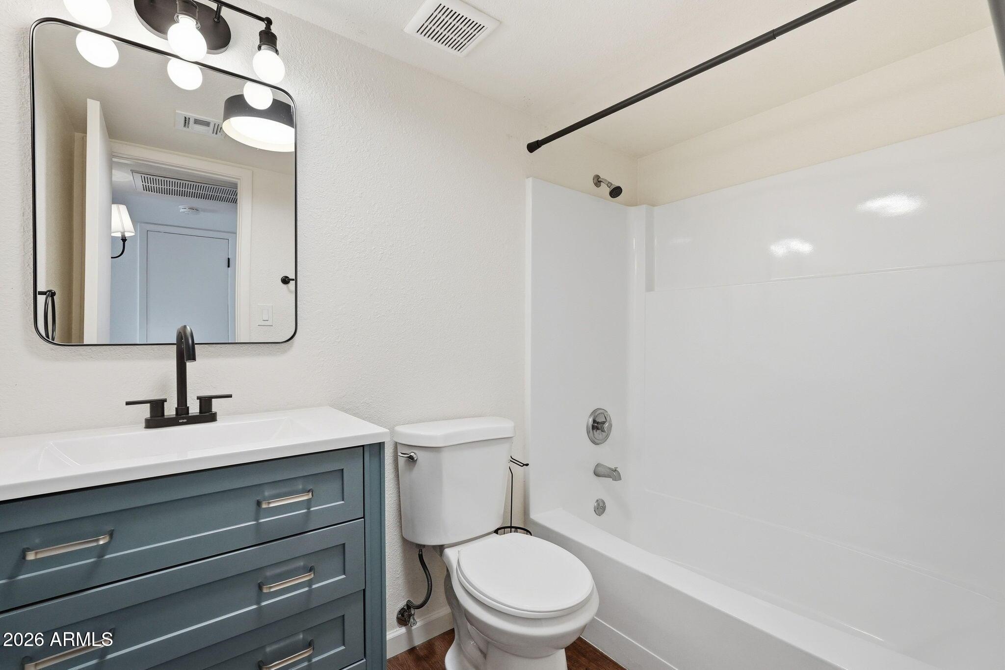 231 North Robson, Unit 7 Mesa, AZ 85201 - Photo 20 of 29 a bathroom with a toilet sink vanity shower and mirror