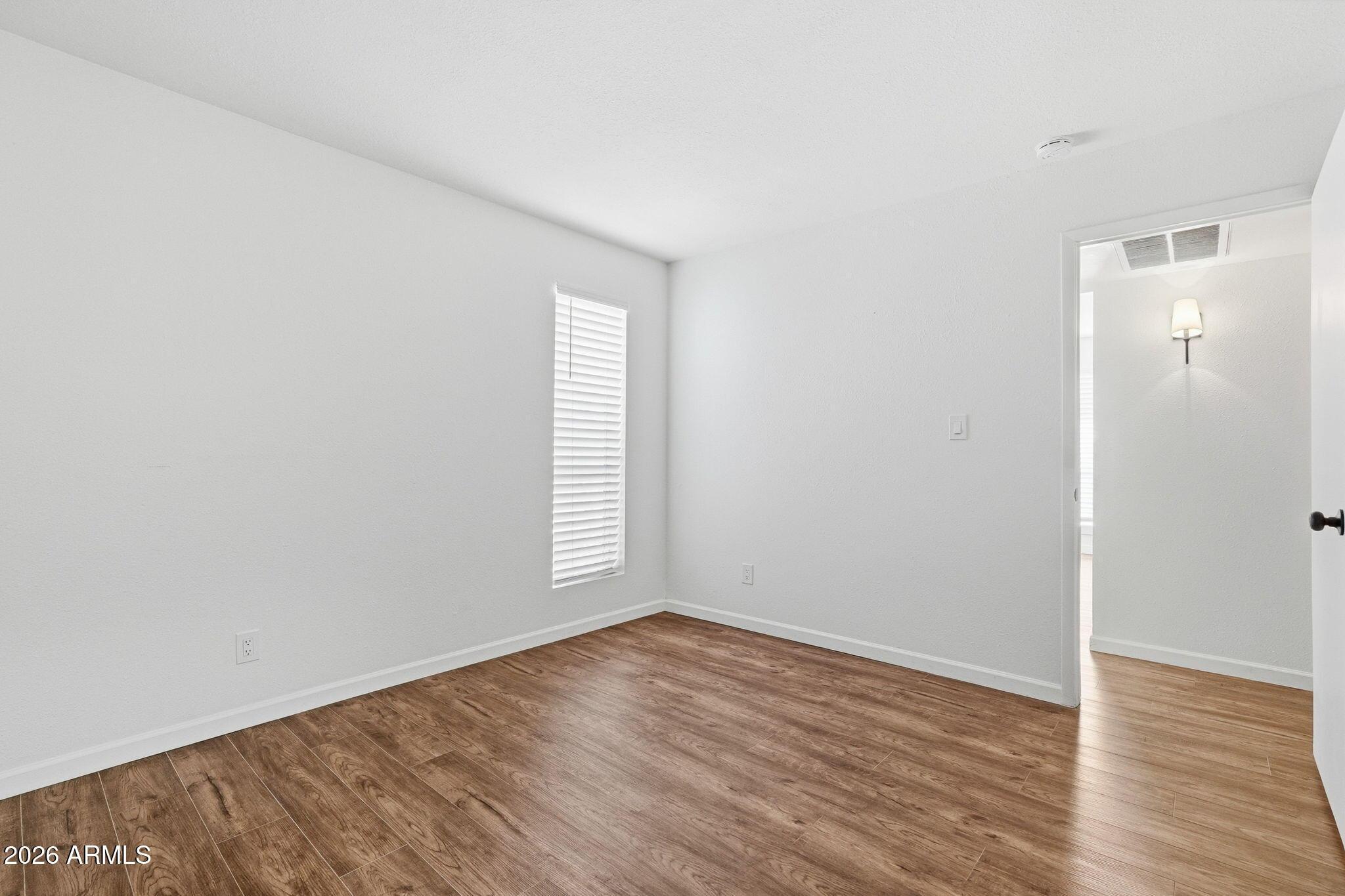 231 North Robson, Unit 7 Mesa, AZ 85201 - Photo 21 of 29 an empty room with wooden floor and windows