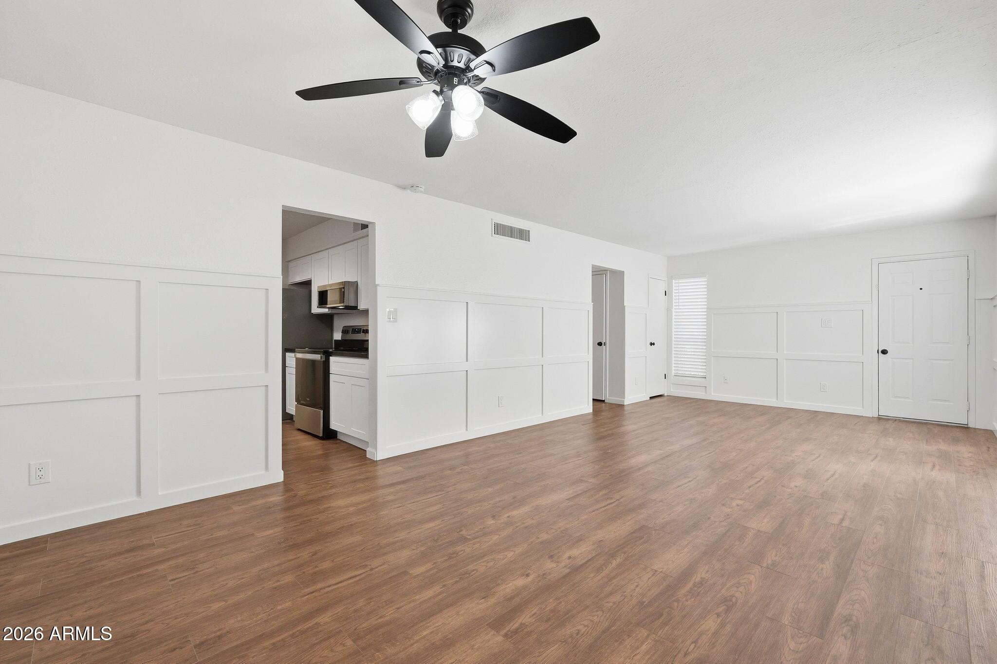 231 North Robson, Unit 7 Mesa, AZ 85201 - Photo 7 of 29 a view of an empty room with wooden floor