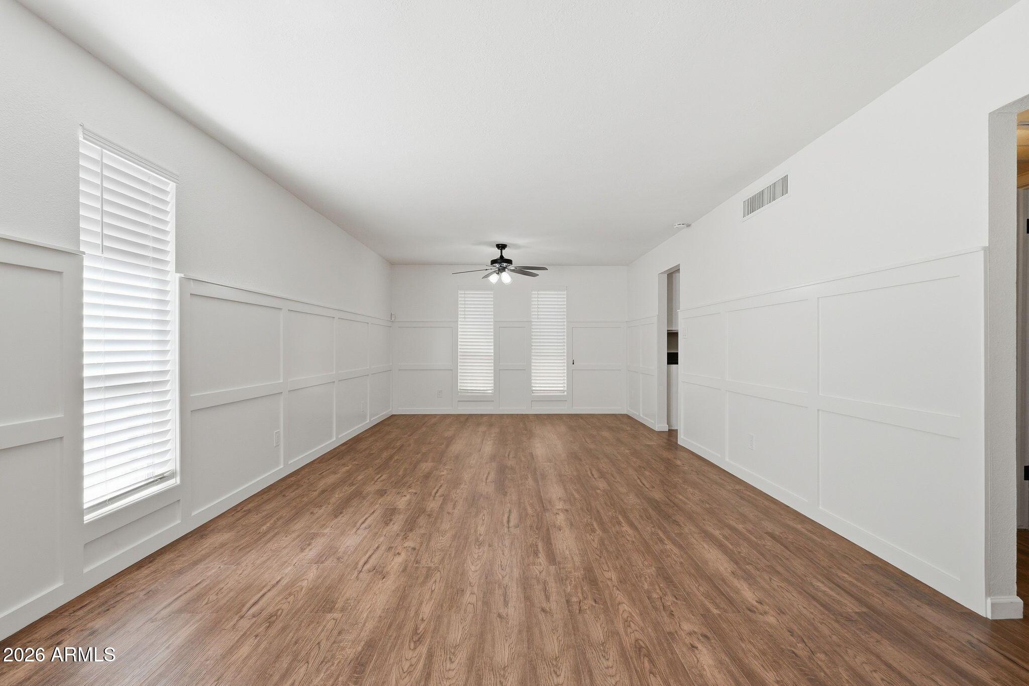 231 North Robson, Unit 7 Mesa, AZ 85201 - Photo 10 of 29 an empty room with wooden floor and windows