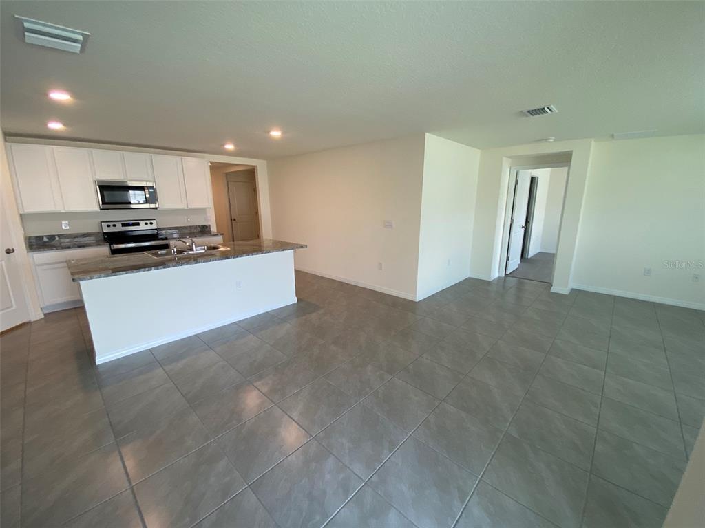 4961 Southwest 88th Place Ocala, FL 34476 - Photo 24 of 50 a view of kitchen with stainless steel appliances a refrigerator and a stove top oven