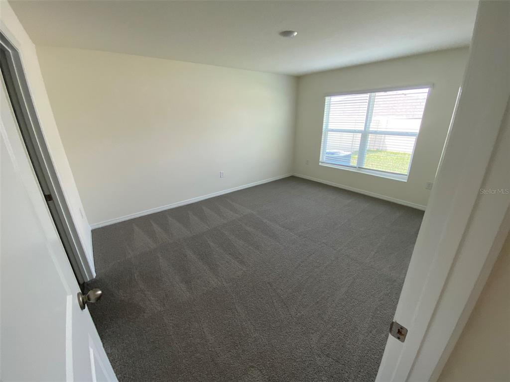 4961 Southwest 88th Place Ocala, FL 34476 - Photo 27 of 50 an empty room with windows