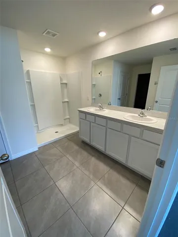 a bathroom with a sink a toilet and mirror