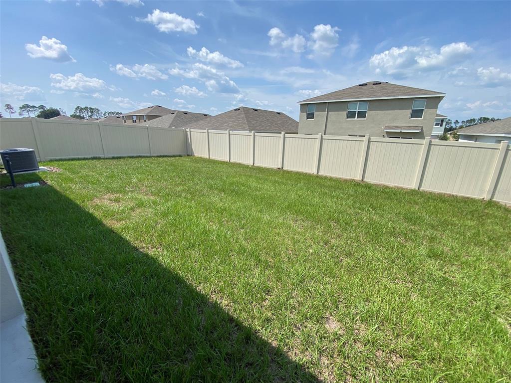 4961 Southwest 88th Place Ocala, FL 34476 - Photo 39 of 50 a view of a backyard with a garden and barbeque oven