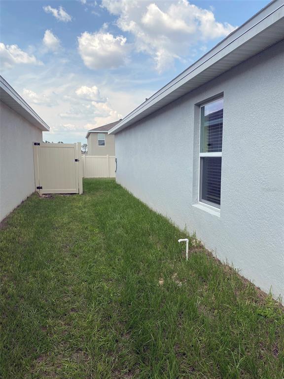 4961 Southwest 88th Place Ocala, FL 34476 - Photo 41 of 50 a backyard of a house with lots of green space and plants