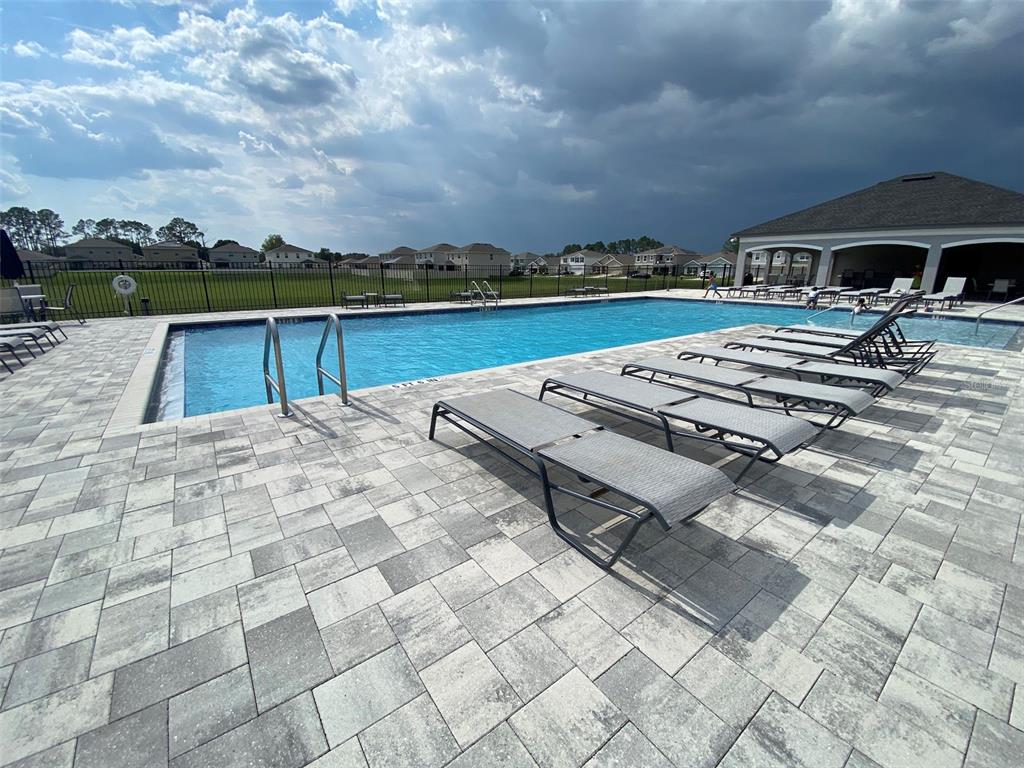 4961 Southwest 88th Place Ocala, FL 34476 - Photo 45 of 50 a view of swimming pool with outdoor seating and yard in back