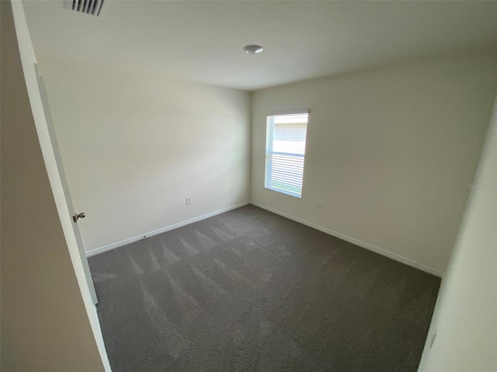 4961 Southwest 88th Place Ocala, FL 34476 - Photo 8 of 50 an empty room with a window