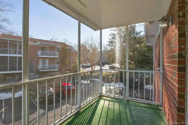 a balcony with view of trees in the background