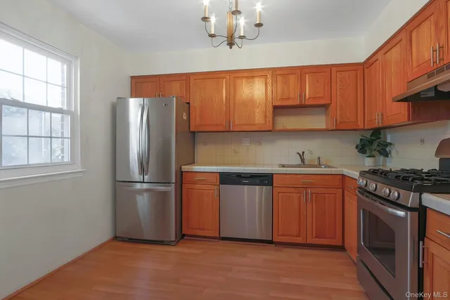 a kitchen with stainless steel appliances granite countertop a refrigerator sink and cabinets