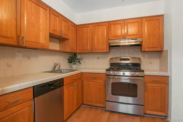 a kitchen with a stove a sink and a microwave