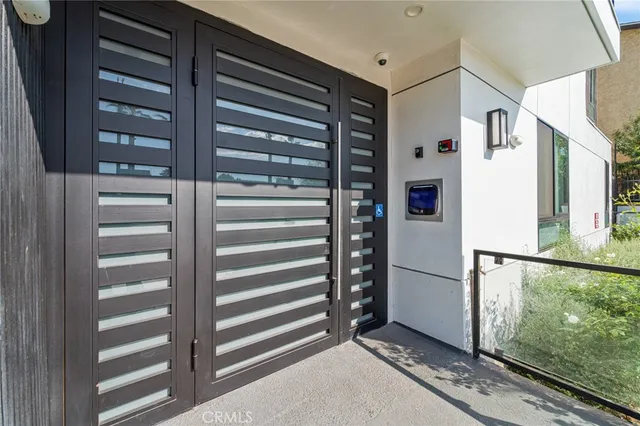 a view of kitchen with stainless steel appliances cabinets and a window