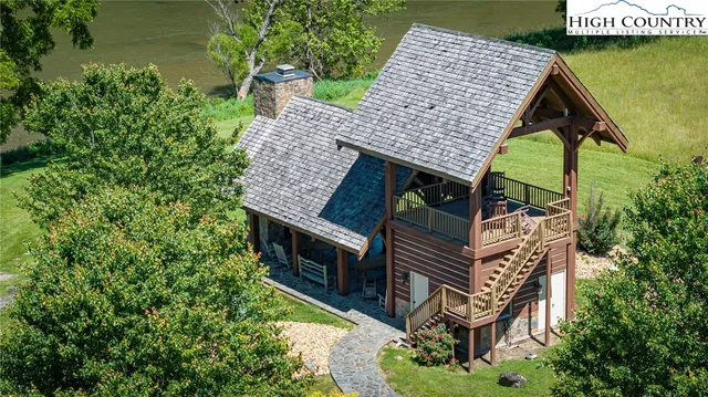 a aerial view of a house with swimming pool and sitting area