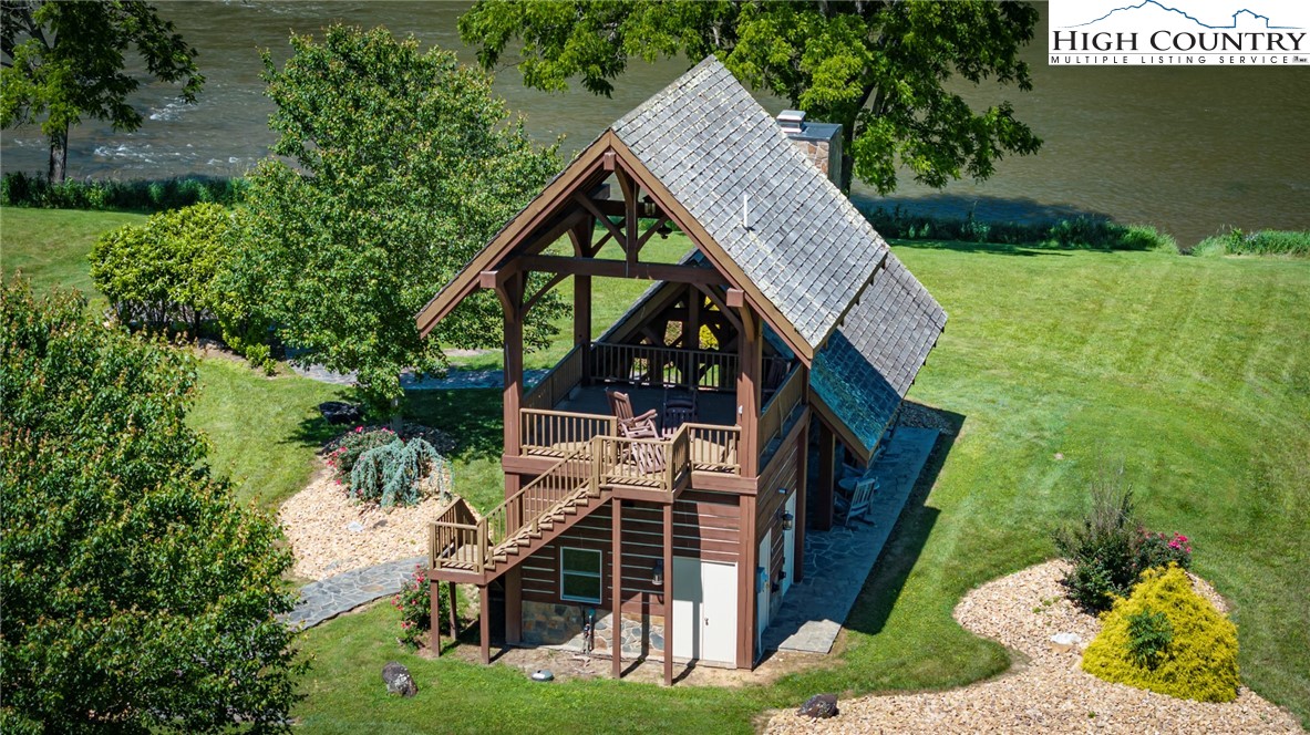 24 Moxley Ridge Road Independence, VA 24348 - Photo 14 of 20 a view of a house with brick walls and a yard with plants