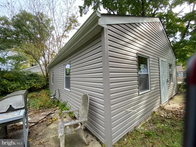 a view of a house with a yard and potted plants
