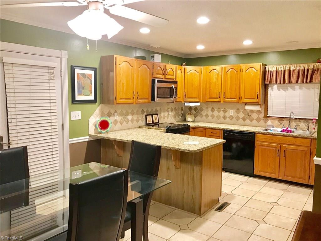 6313 Radds Street Lexington, NC 27295 - Photo 4 of 11 Kitchen updated with Granite tops, tile backsplash and LED can lights!