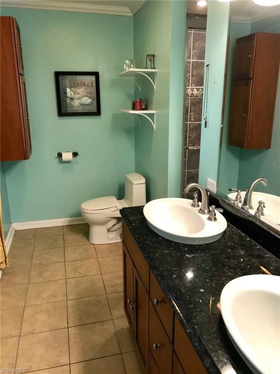 6313 Radds Street Lexington, NC 27295 - Photo 7 of 11 Updated Master Bath featuring Tile floors, double vanity w/Granite top and GIANT tile shower!