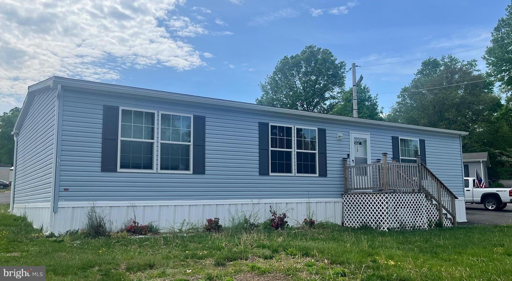 a view of a house with a yard and deck