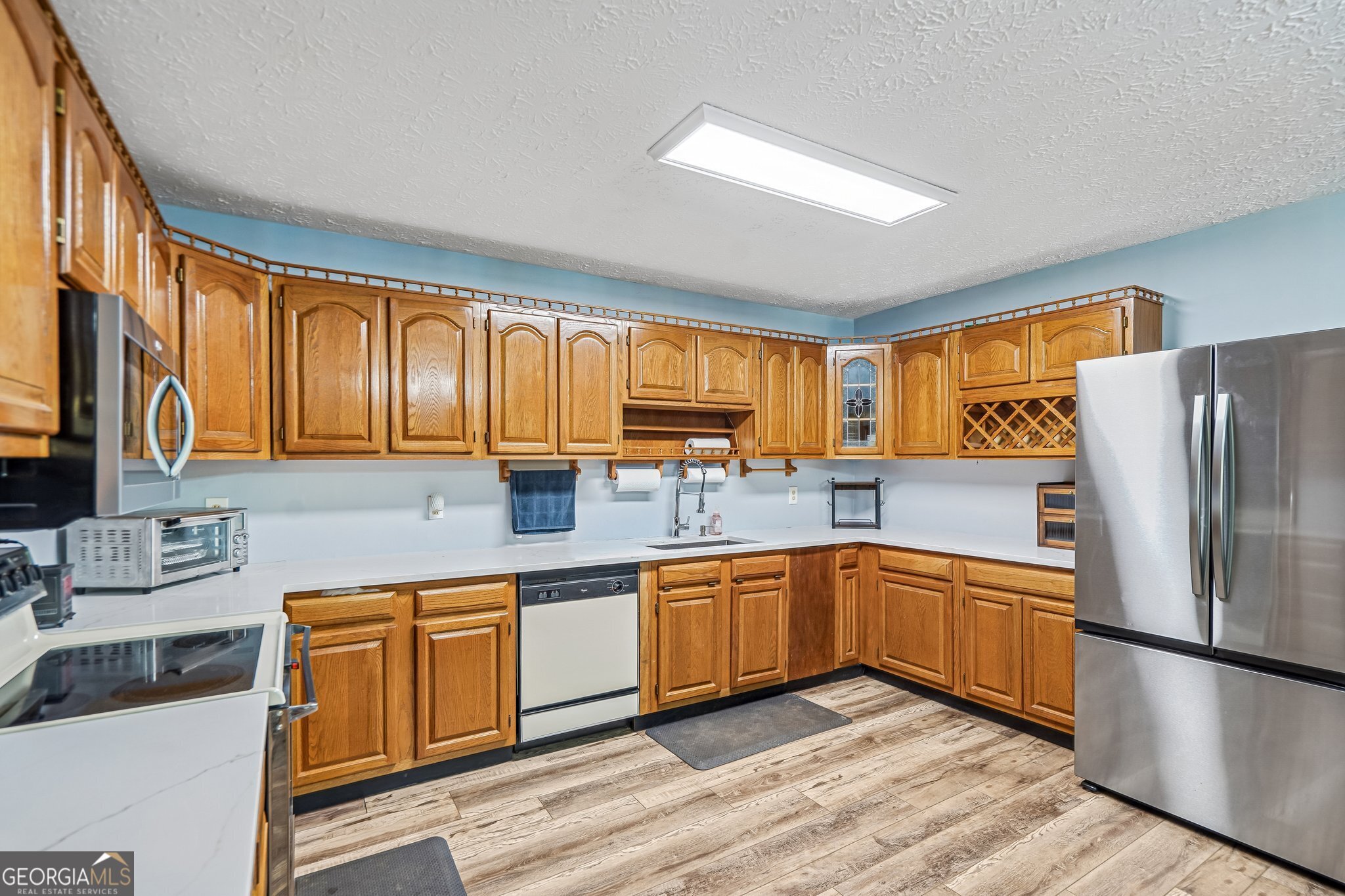 241 Busbin Road Fayetteville, GA 30215 - Photo 14 of 45 a kitchen with stainless steel appliances granite countertop a refrigerator sink and cabinets