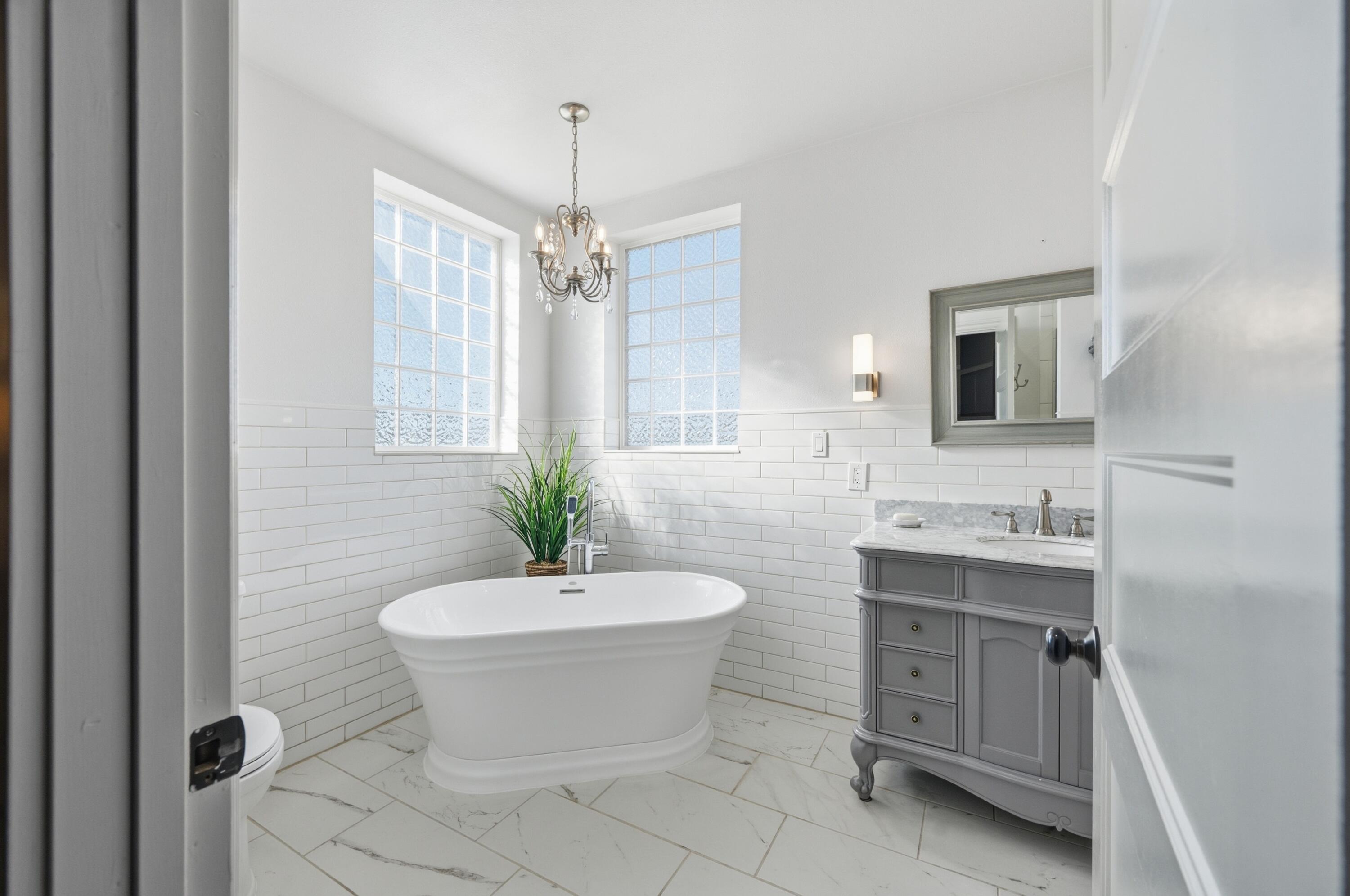4074 Southwest Reif Road Powell Butte, OR 97753 - Photo 16 of 59 a bathroom with a sink toilet a mirror and shower