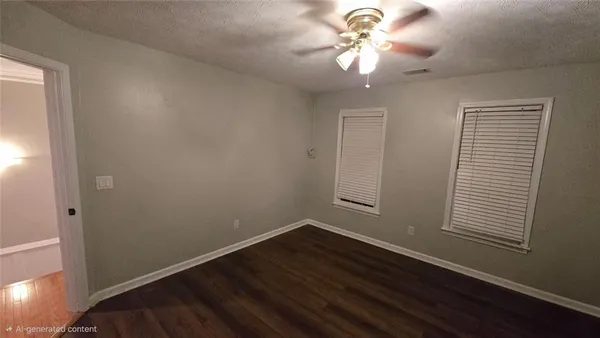 a view of a room with a fan a fan and a window