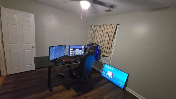 a view of a workspace with furniture and wooden floor