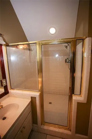 a bathroom with a shower and a sink