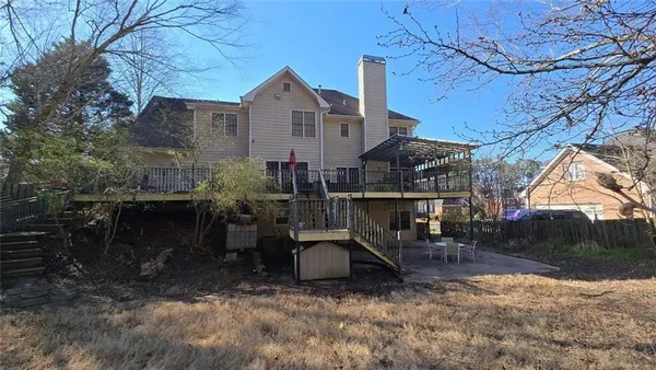 a view of a house with backyard and sitting area