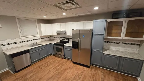 a kitchen with a refrigerator stove and sink