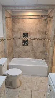 a bathroom with a toilet and a shower