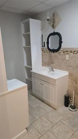 a bathroom with a sink a vanity and a mirror