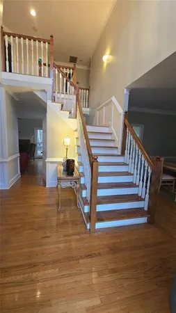 a view of entryway and hall with wooden floor