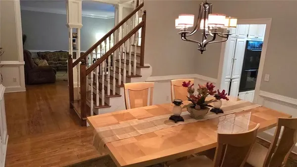 a view of a dining room with furniture and wooden floor