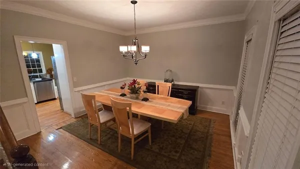 a view of a dining room with furniture wooden floor and chandelier
