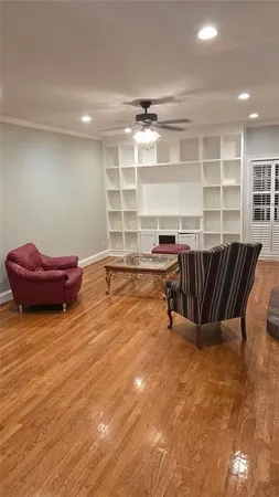 a living room with a bookshelf and furniture
