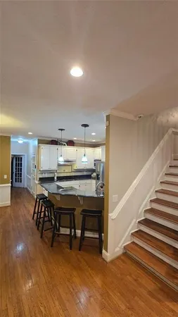 a view of a dining room with furniture and wooden floor