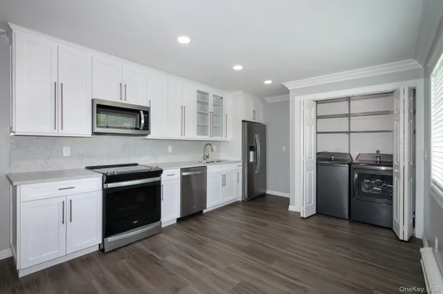 a kitchen with stainless steel appliances granite countertop a refrigerator stove and sink