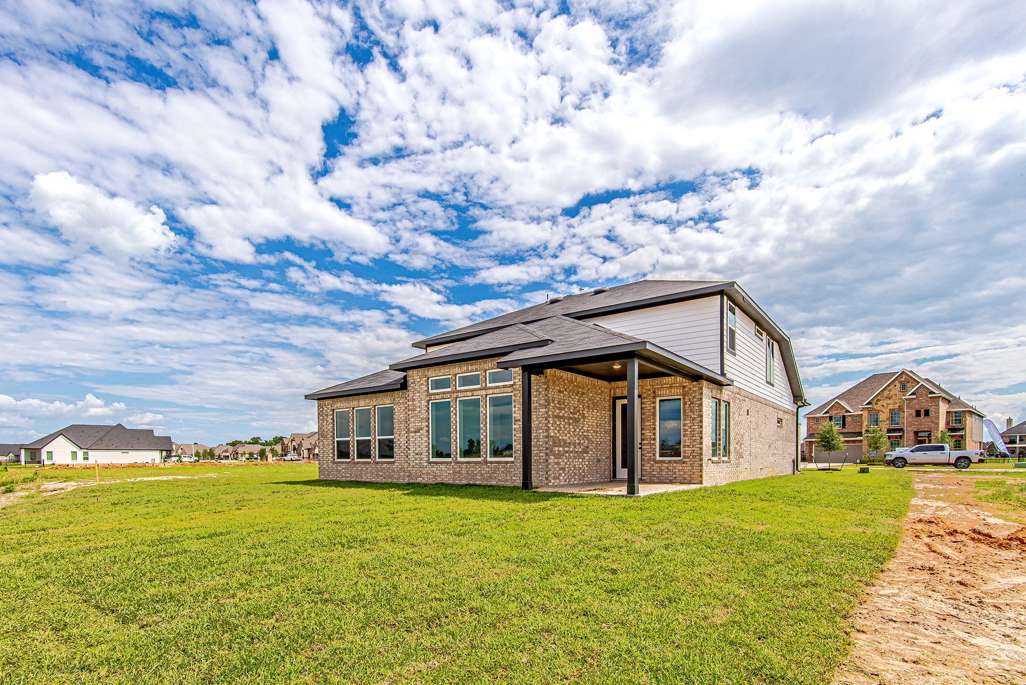 141 Peninsula Point Drive Montgomery, TX 77356 - Photo 39 of 47 Expansive backyard with a generous covered patio—ideal for outdoor dining, entertaining, or simply relaxing under wide-open Texas skies.