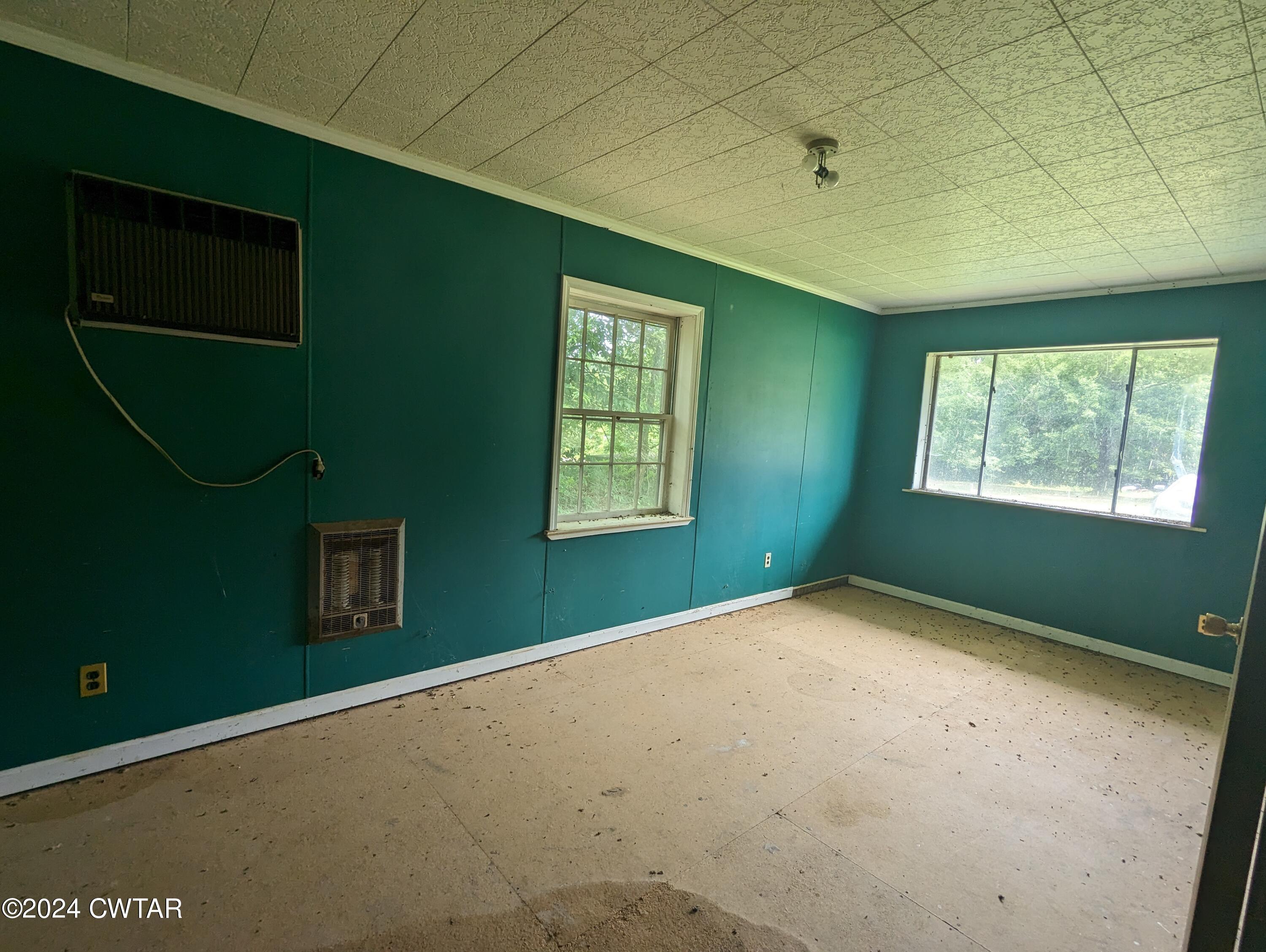 650 Old Finger Road Henderson, TN 38340 - Photo 12 of 19 a view of an empty room with a window and a fireplace