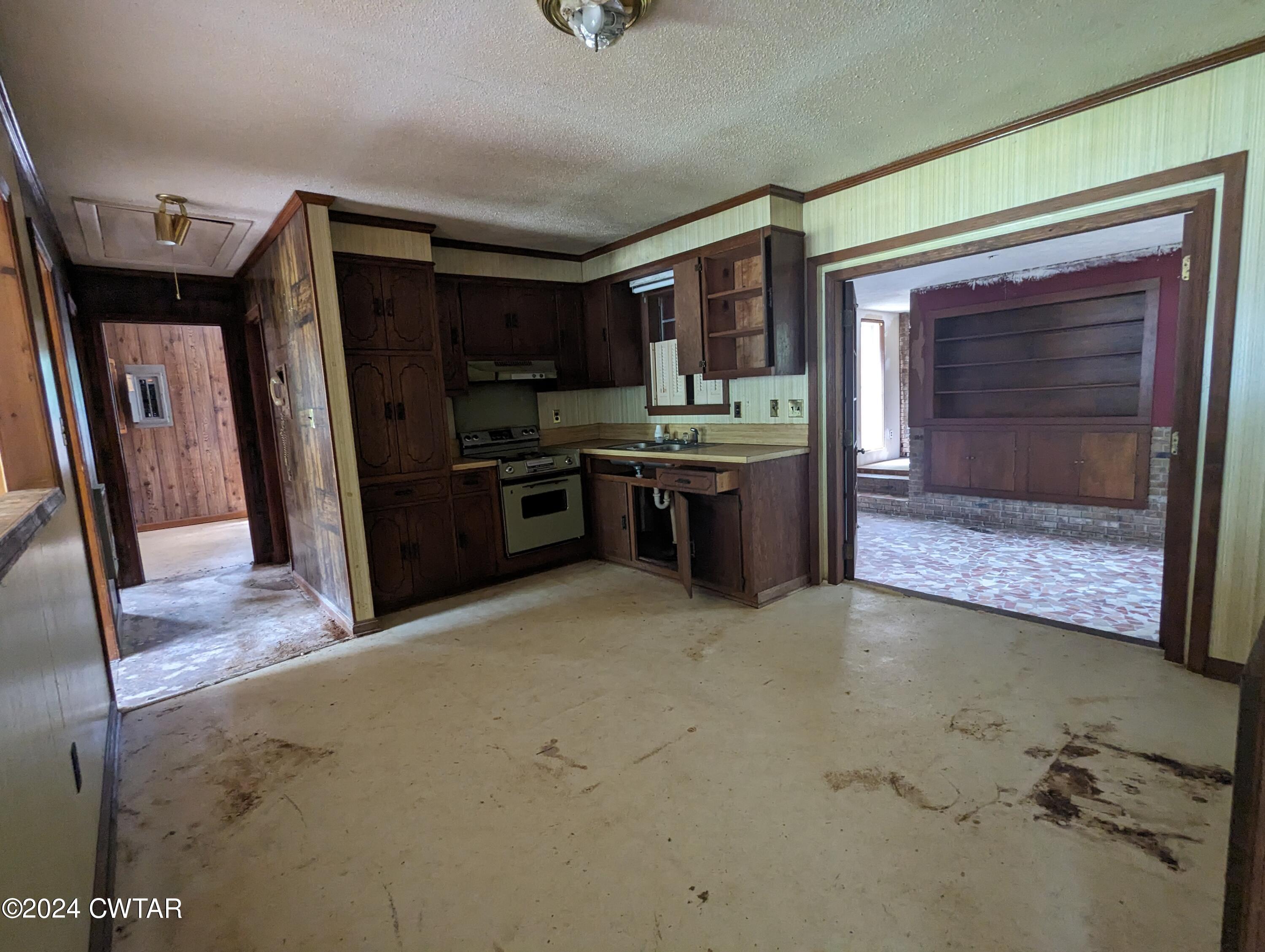 650 Old Finger Road Henderson, TN 38340 - Photo 7 of 19 a large kitchen with cabinets and stainless steel appliances