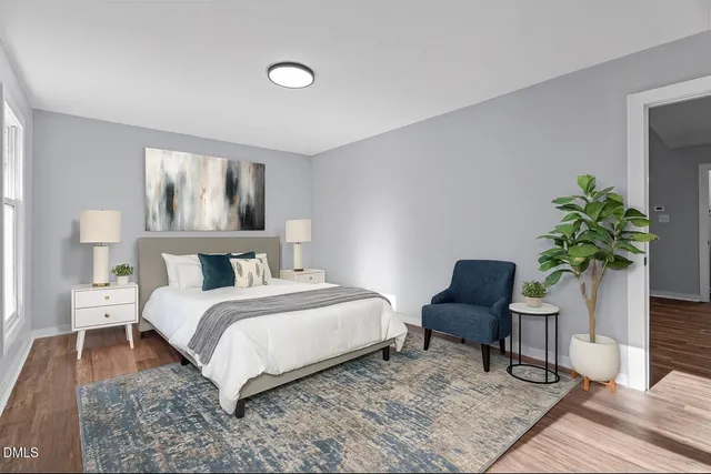 a bathroom with a granite countertop toilet sink and mirror